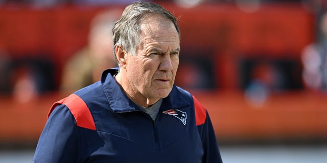 Head coach Bill Belichick of the New England Patriots walks onto the field prior to a game against the Cleveland Browns at FirstEnergy Stadium on Oct. 16, 2022, in Cleveland.