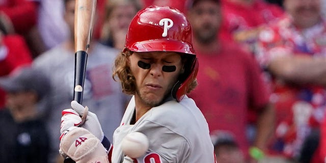 The Philadelphia Phillies' Alec Bohm is hit by a pitch during the ninth inning in Game 1 of a National League wild-card series against the St. Louis Cardinals, Friday, Oct. 7, 2022, in St. Louis.