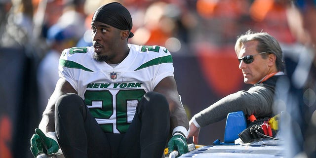 Breece Hall #20 of the New York Jets is carted off the field after an apparent injury following a play against the Denver Broncos during the first half at Empower Field At Mile High on October 23, 2022, in Denver, Colorado.