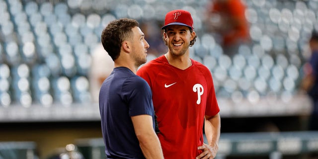 Aaron Nola, #27 of the Philadelphia Phillies, talks with Alex Bregman, #2 of the Houston Astros, before the game at Minute Maid Park on Oct. 5, 2022 in Houston.