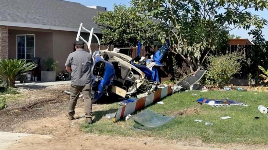 A picture of people inspecting the helicopter after the crash.