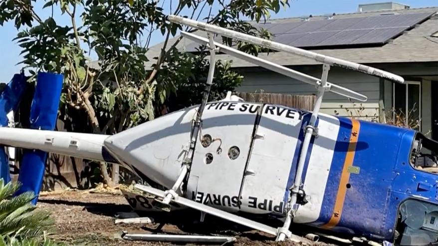 A picture of the helicopter after is crashed near a home.