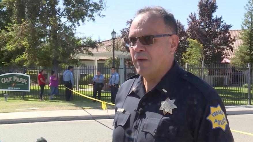 A picture of a Fresno Police officer talking to the media.