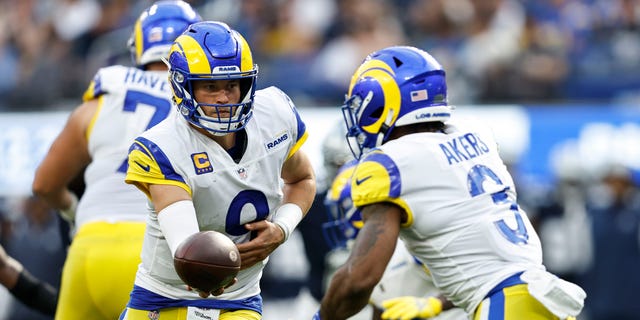 Matthew Stafford (9) of the Los Angeles Rams hands off to Cam Akers during the game against the Dallas Cowboys at SoFi Stadium on Oct. 9, 2022, in Inglewood, California.