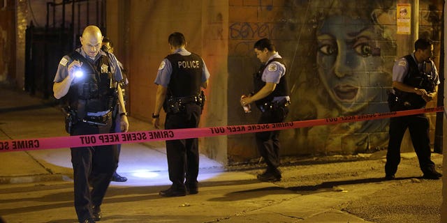 Chicago Police officers investigate the crime scene where a man was shot in the alley in the Little Village neighborhood on July 2, 2017 in Chicago, Illinois. A South Carolina sheriff’s deputy was shot and an armed suspect was killed in July, authorities said. 