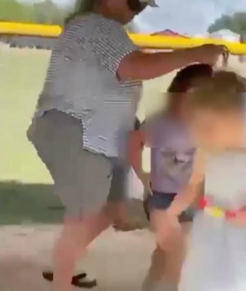 The footage also appears to show the worker grabbing a young girl by the hair.