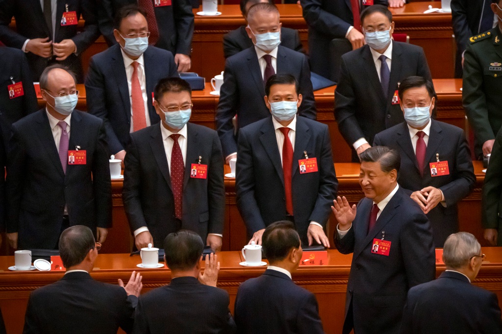 Chinese President Xi Jinping waves as he leaves the opening ceremony of the 20th National Congress of China's ruling Communist Party at the Great Hall of the People in Beijing, China, Sunday, Oct. 16, 2022