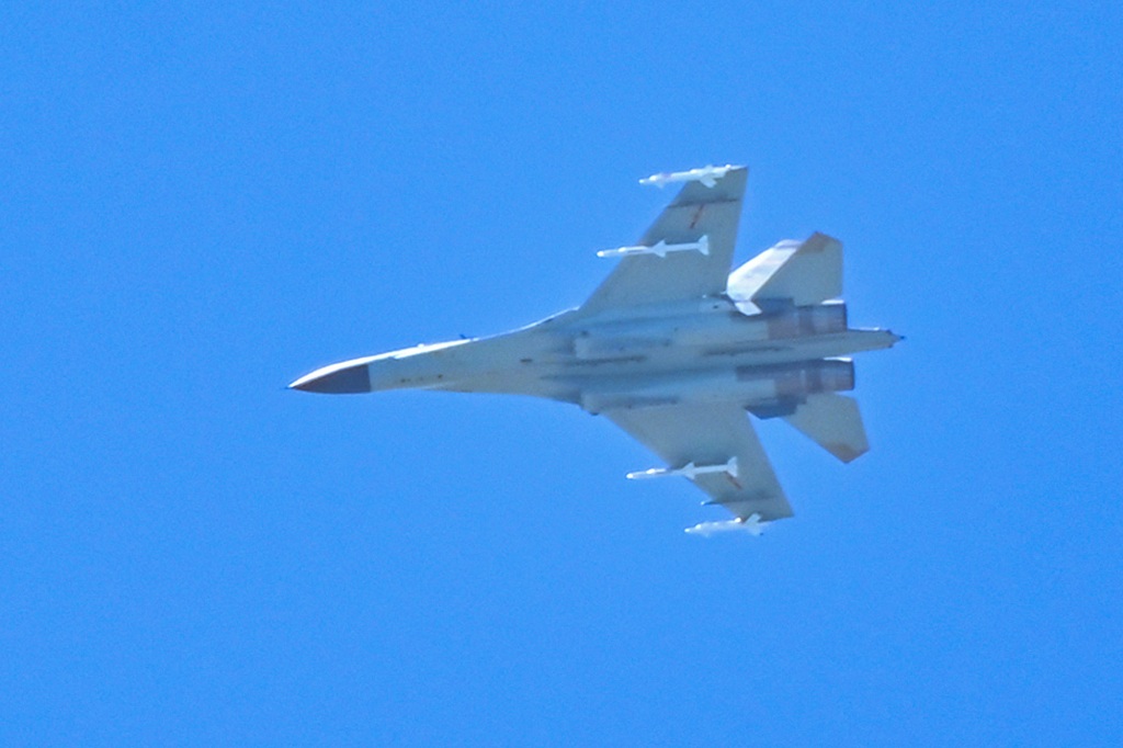 A Chinese military jet flies over Pingtan island, one of mainland China's closest point from Taiwan, in Fujian province on August 5, 2022