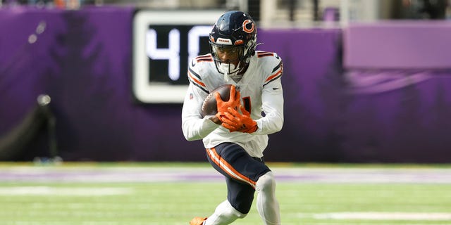 Darnell Mooney #11 of the Chicago Bears runs the ball after catching a pass during the third quarter against the Minnesota Vikings at U.S. Bank Stadium on October 09, 2022 in Minneapolis, Minnesota. 