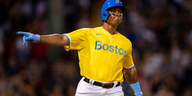 Rafael Devers #11 of the Boston Red Sox reacts after hitting a three-run home run during the sixth inning of a game against the New York Yankees on September 24, 2021 at Fenway Park in Boston, Massachusetts.