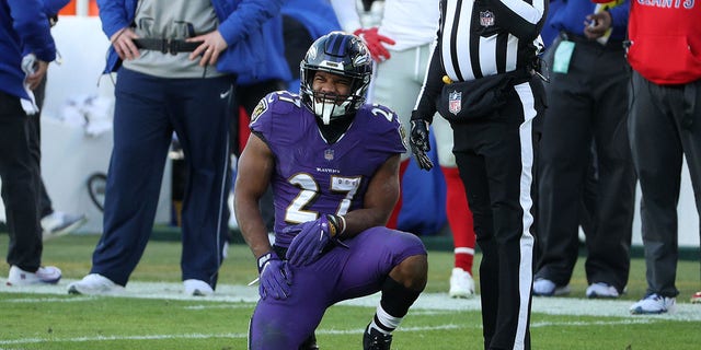 Running back J.K. Dobbins #27 of the Baltimore Ravens reacts after being hit by linebacker Cameron Brown #47 of the New York Giants during the third quarter at M&amp;T Bank Stadium on Dec.  27, 2020, in Baltimore, Maryland.