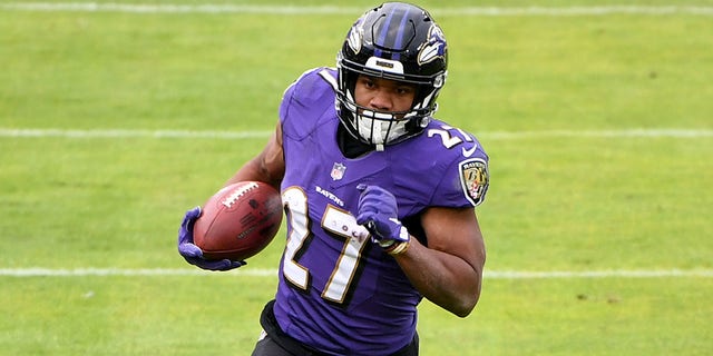 Running back J.K. Dobbins #27 of the Baltimore Ravens runs against the Jacksonville Jaguars during the first half at M&amp;T Bank Stadium on Dec. 20, 2020, in Baltimore, Maryland.