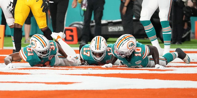 Raheem Mostert #31 of the Miami Dolphins celebrates his touchdown with teammates during the first quarter against the Pittsburgh Steelers at Hard Rock Stadium on October 23, 2022, in Miami Gardens, Florida. 