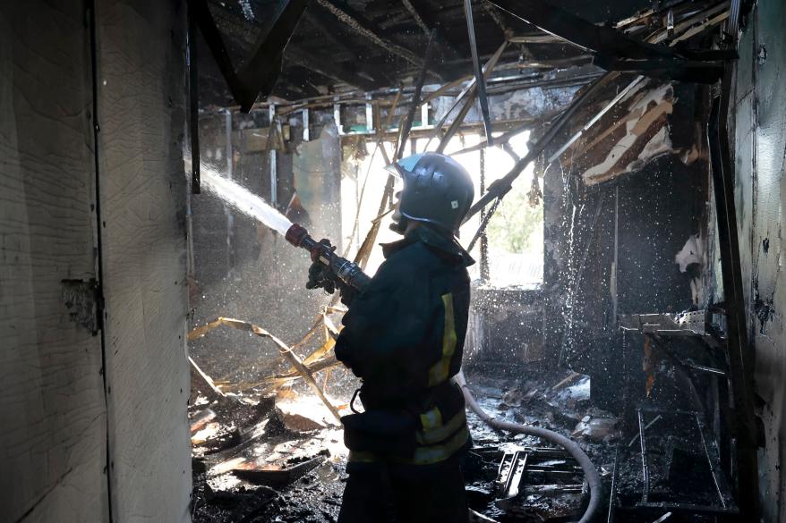 A firefighter working at the site of the shelling in Donetsk.