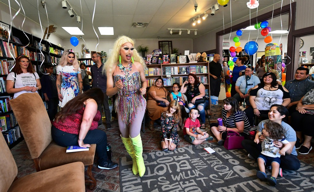 Drag queens Athena Kills (C) and Scalene Onixxx arrive to awaiting adults and children for Drag Queen Story Hour at Cellar Door Books in Riverside, California on June 22, 2019.