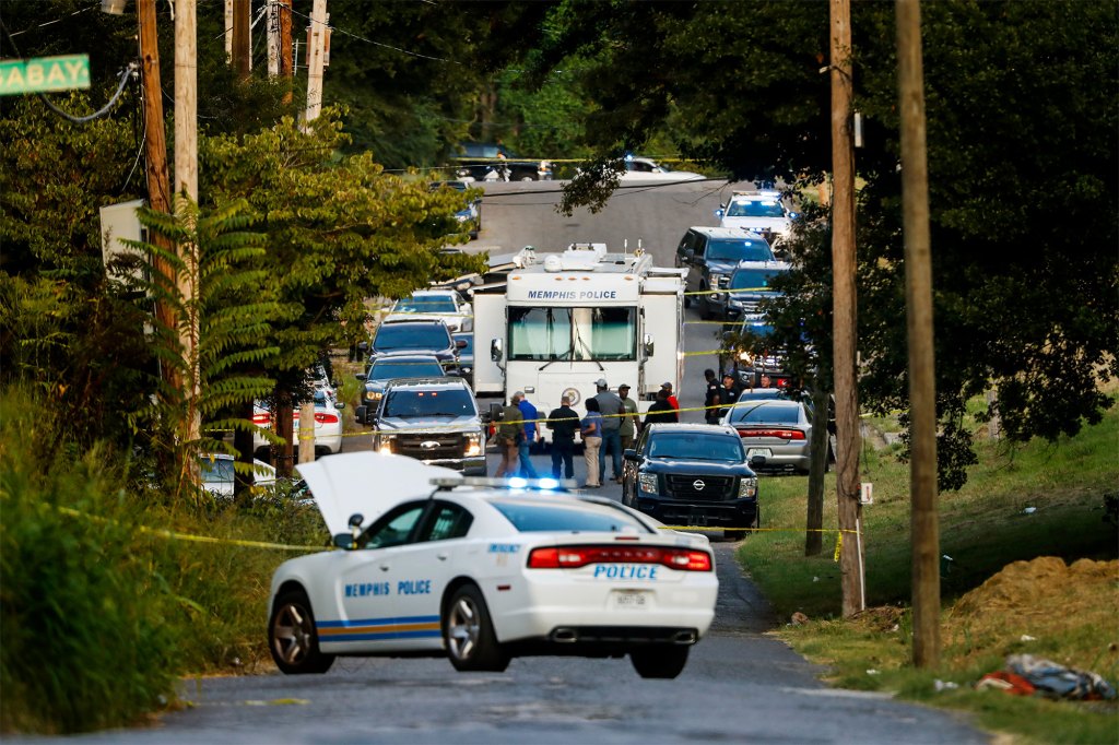 Memphis police officers search an area where a body had been found in South Memphis, Tennessee on September 5. 