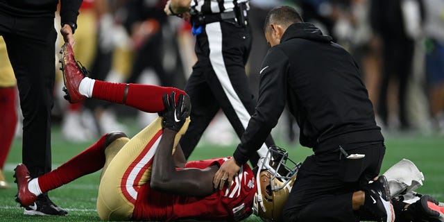 Emmanuel Moseley of the San Francisco 49ers holds his knee during the second half against the Carolina Panthers at Bank of America Stadium on Oct. 9, 2022, in Charlotte, North Carolina.