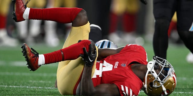 Emmanuel Moseley of the San Francisco 49ers holds his knee during the second half against the Carolina Panthers at Bank of America Stadium on Oct. 9, 2022, in Charlotte, North Carolina.