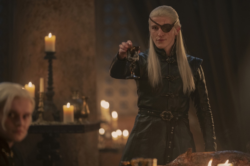 Aemond Targaryen (Ewan Mitchell) standing and looking sinister in an eye patch. 