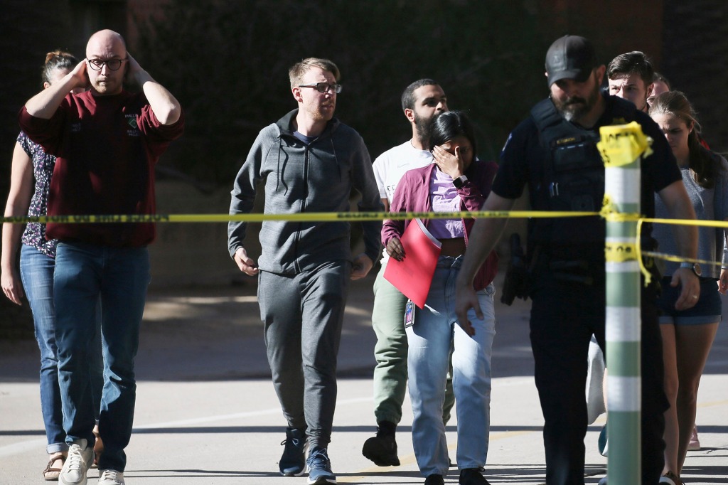 University of Arizona Police escort students from the scene 