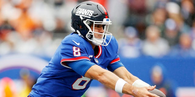 Daniel Jones #8 of the New York Giants hands off the ball during the game against the Chicago Bears at MetLife Stadium on Oct. 2, 2022 in East Rutherford, New Jersey. 