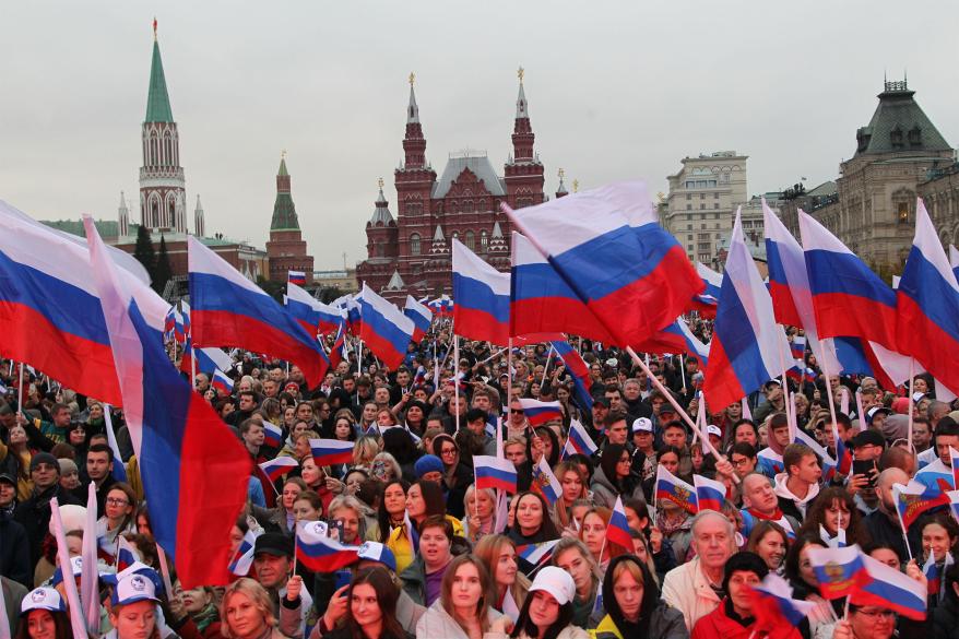 People wave Russian flags during a concert in support of the annexation.