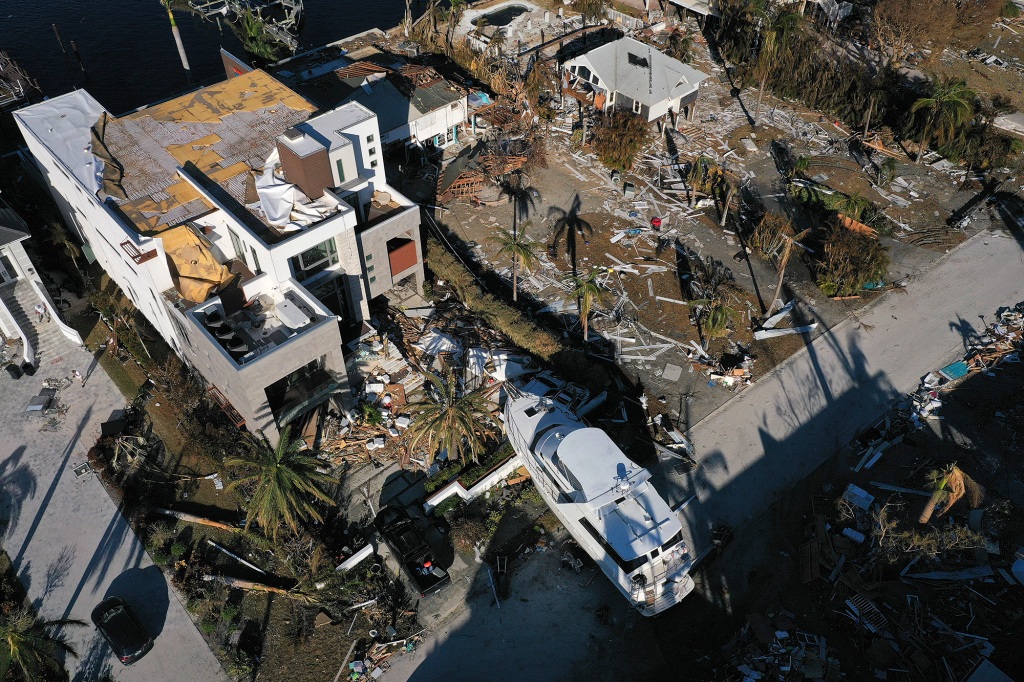 A yacht sits in the front yard of a home In the wake of Hurricane Ian on October 02, 2022 in Fort Myers, Florida