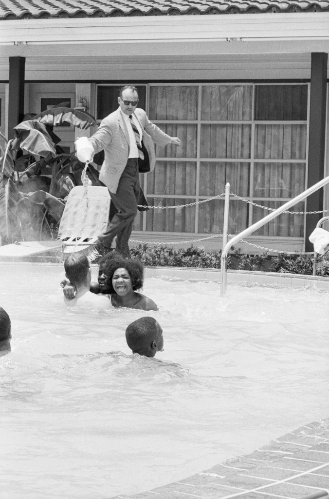 Protesters demonstrating in the swimming pool of the Monson Motor Lodge in Saint Augustine, Florida scream as motel manager James Brock dumps "muriatic acid" into the water.