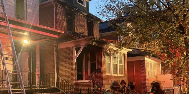 Firefighters observe the home after putting out the flames. 