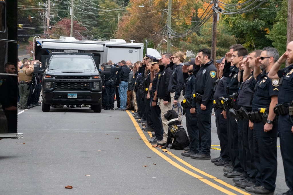 Connecticut police officers at a procession for the bodies of the two slain officers as they are transported from the crime scene on October 13, 2022.