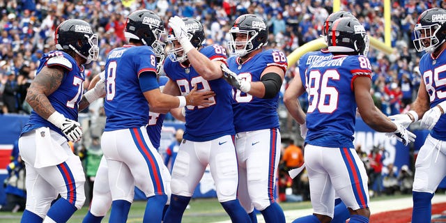 New York Giants teammates celebrate with Daniel Jones (8) after a touchdown during the first quarter against the Chicago Bears at MetLife Stadium on Oct. 2, 2022, in East Rutherford, New Jersey.