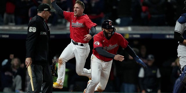 Amed Rosario #1 of the Cleveland Guardians celebrates after scoring a run during the ninth inning any in game three of the American League Division Series at Progressive Field on October 15, 2022 in Cleveland, Ohio.