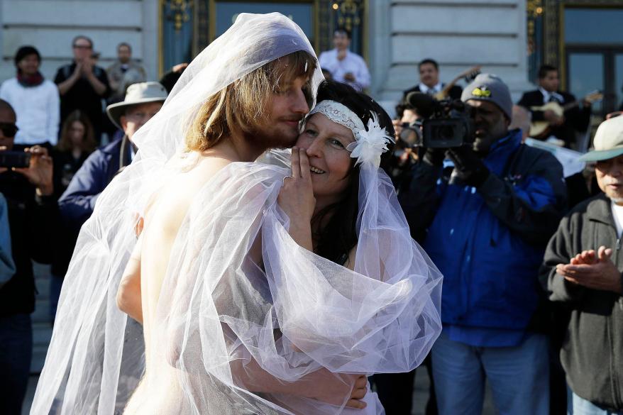 Oxana "Gypsy" Taub embraces Jaymz Smith during their nude wedding outside San Francisco City Hall in December 2013.