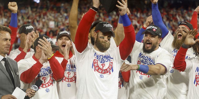 Bryce Harper #3 of the Philadelphia Phillies lifts the National League Championship Series MVP trophy after the Phillies defeated the San Diego Padres in game five to win the National League Championship Series at Citizens Bank Park on October 23, 2022, in Philadelphia, Pennsylvania.