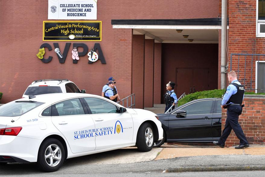 St. Louis metropolitan police officers stand outside an entrance at the northeast corner of the Central Visual and Performing Arts High School.