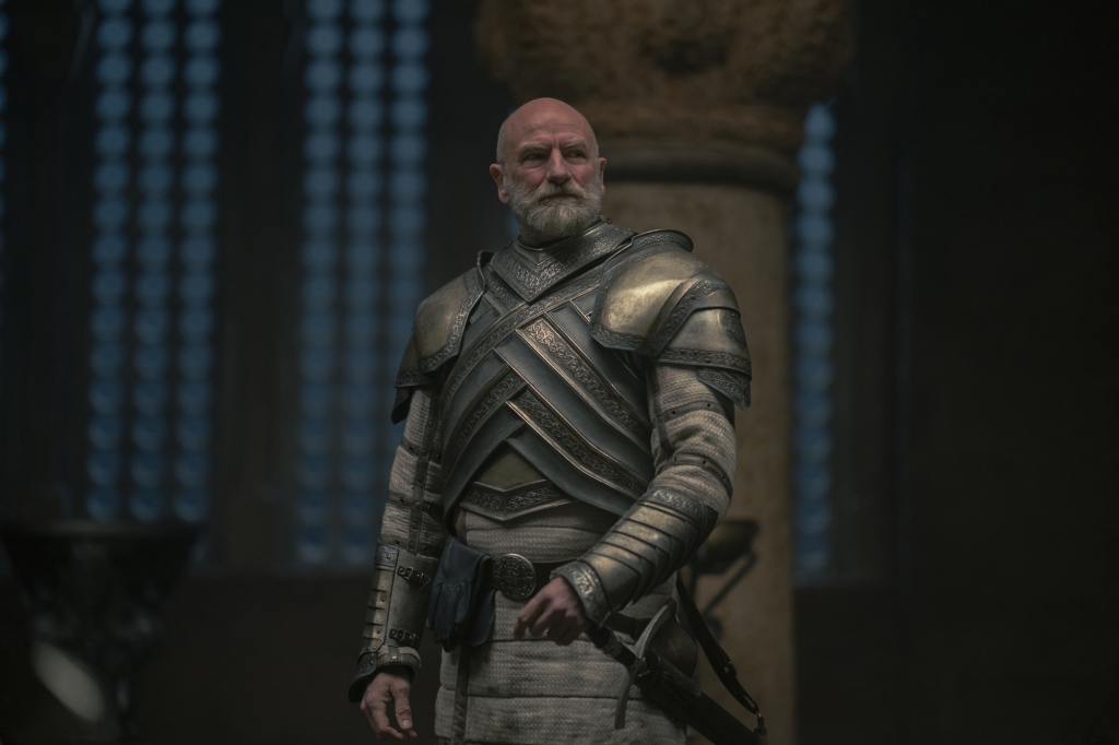 Lord Commander of the Kingsguard Ser Westerling (Graham McTavish) stands in a room looking grim. 