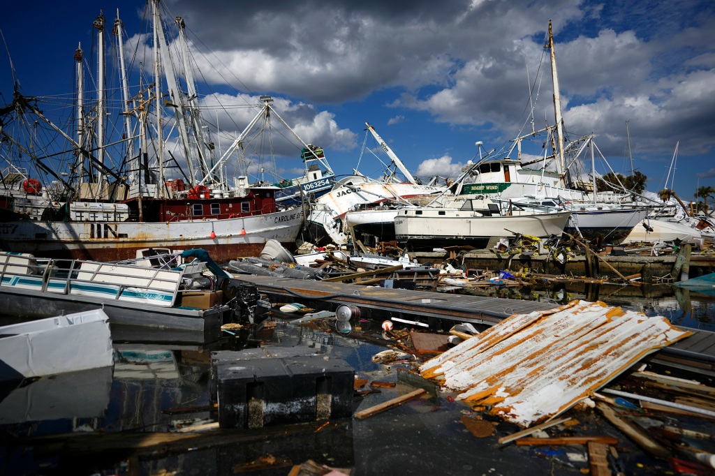 Shrimp boats that came from further down the coast sit atop the remains of a mobile home park, Wednesday, Oct. 5, 2022,  on San Carlos Island, Fort Myers Beach, Fla.