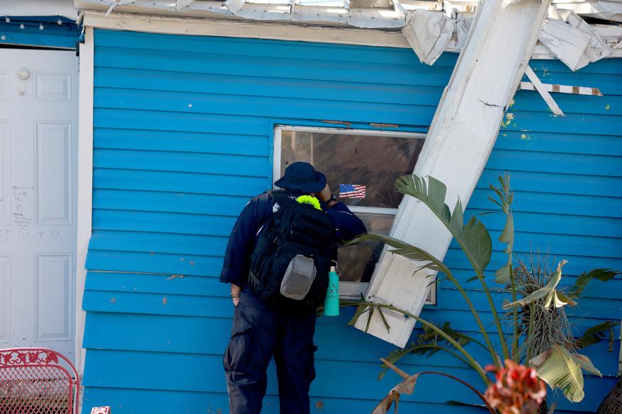 A member of the Indiana Task Force 1 Search and Rescue team looks for anyone needing help after Hurricane Ian passed through the area on October 1, 2022 in Fort Myers, Florida.