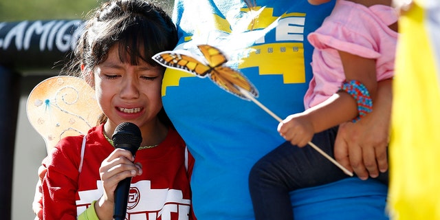 Akemi Vargas, 8, cries as she talks about being separated from her father during an immigration family separation protest in front of the Sandra Day O'Connor U.S. District Court building in Phoenix.