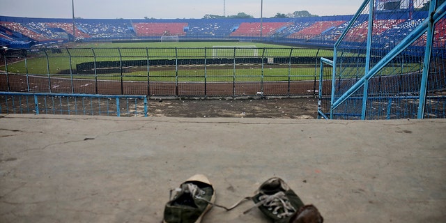 A pair of sneakers sit trampled in the stands of Kanjuruhan Stadium following a deadly soccer match stampede, in Malang, East Java, Indonesia, Sunday, Oct. 2, 2022.