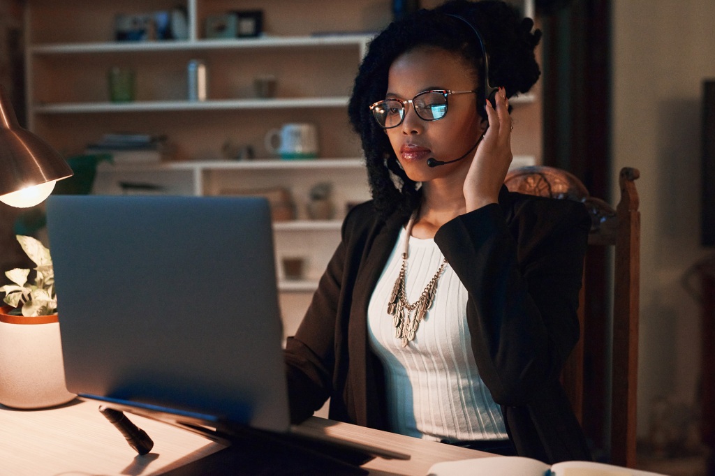 A picture of a customer service representative working from her home office.