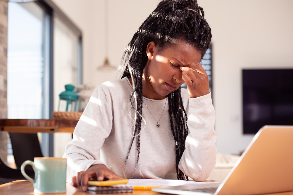 A picture of a stressed businesswoman working from home. 