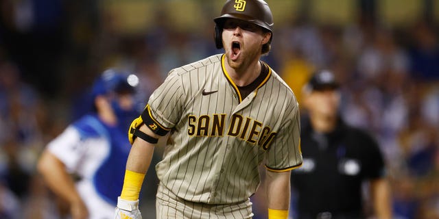 Jake Cronenworth #9 of the San Diego Padres celebrates his solo home run in the eighth inning during game two of the National League Division Series against the Los Angeles Dodgers at Dodger Stadium on October 12, 2022 in Los Angeles, California.