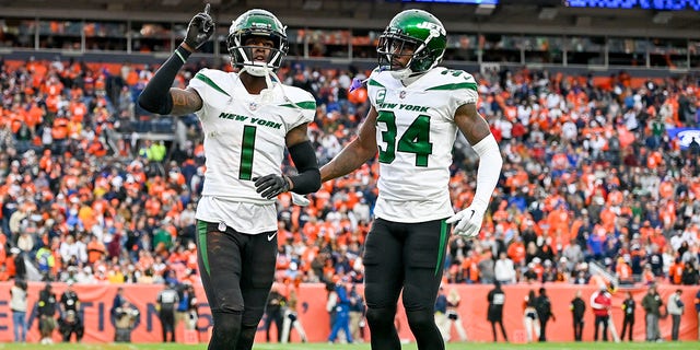 Sauce Gardner #1 and Justin Hardee #34 of the New York Jets react after a play against the Denver Broncos during the second half at Empower Field At Mile High on October 23, 2022, in Denver, Colorado.