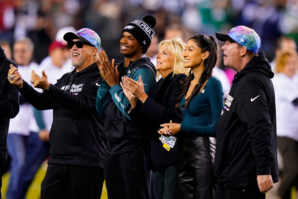 First lady Jill Biden, center, stands on the field before an NFL football game between the Philadelphia Eagles and Dallas Cowboys on Sunday, Oct. 16, 2022, in Philadelphia
