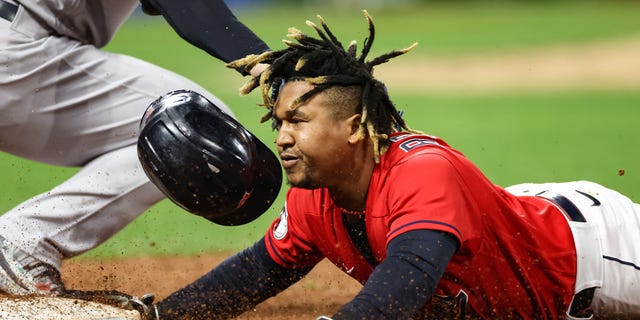 Jose Ramirez #11 of the Cleveland Guardians is tagged out at first base by Anthony Rizzo #48 of the New York Yankees during the third inning in game four of the American League Division Series at Progressive Field on Oct. 16, 2022 in Cleveland, Ohio.