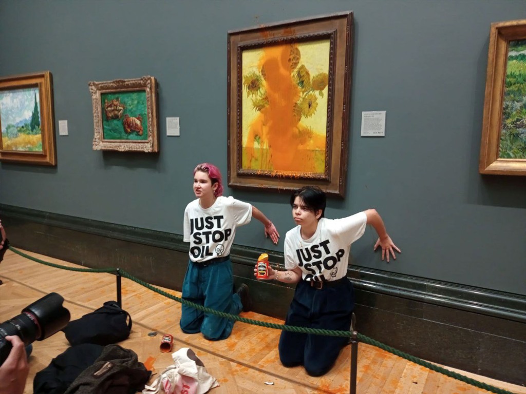 The pair glued themselves to the wall beneath the $85 million artwork before they were arrested by Scotland Yard. 