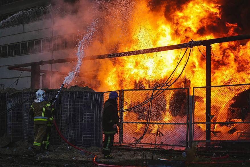 Firefighters working to put out a blaze at an energy infrastructure facility in Kyiv.