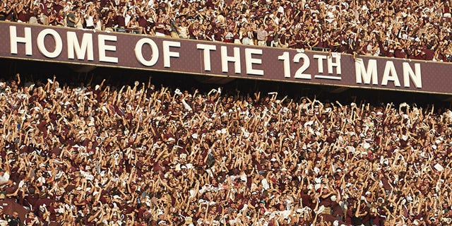 College Football: Overall view of fans in stands during Texas A&amp;amp;M vs Alabama game at Kyle Field. View of banner sign reading HOME OF THE 12TH MAN. College Station, TX 9/14/2013