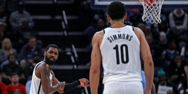 Kyrie Irving #11 of the Brooklyn Nets gestures towards Ben Simmons #10 during the game against the Memphis Grizzlies at FedExForum on October 24, 2022 in Memphis, Tennessee. 